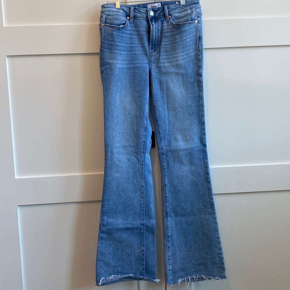 Paige flare long distressed jeans in medium light wash.